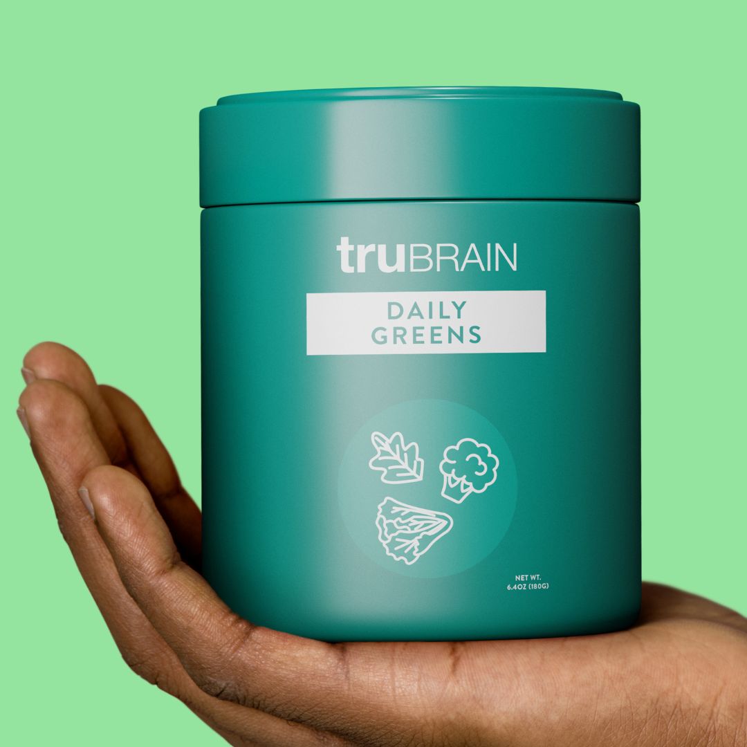 Hand holding a jar of Sustained brain nourishment. Takes the best of the plant-based world to address stress, gut-brain connection, immunity & brain aging.