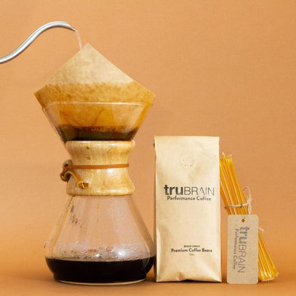Closeup of the Focus Sticks in TruBrain’s Coffee kit being dropped into a cup of coffee to show how the natural nootropic is used to pair with coffee