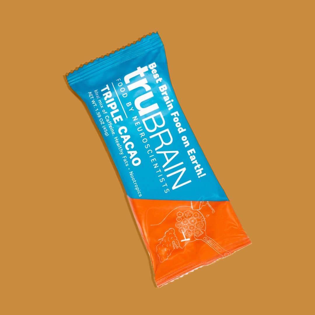 Closeup hero shot on blue background of the front of TruBrain’s Bars which has Nootropics, Healthy fats & Caffeine in a Food Bar