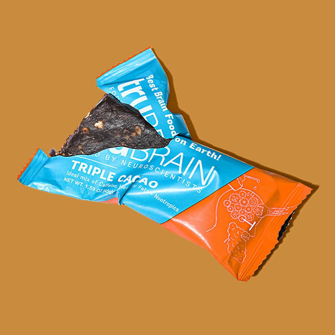 TruBrain’s Bars ripped open to reval half the bar showcase the contents of the bar, Nootropics, Healthy fats & Caffeine